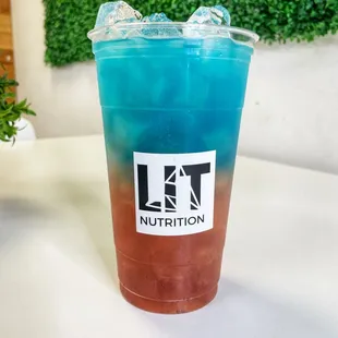 a blue and red drink in a plastic cup
