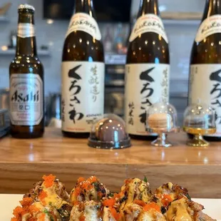 a plate of sushi and beer bottles