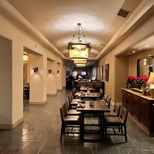 a long hallway with tables and chairs