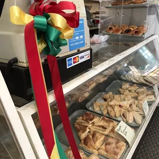 Counter with many sweets. I still need to try those kolaches in the plastic display container on top of the counter.