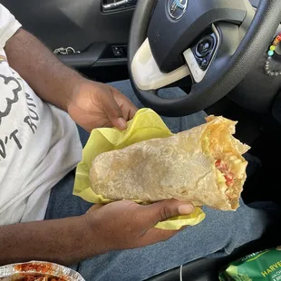 a man eating a burrito