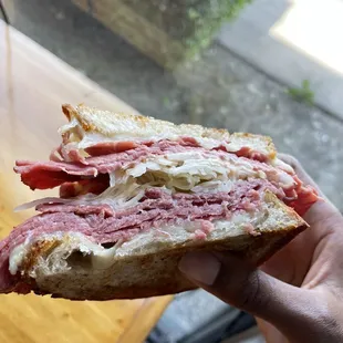 a person holding a sandwich