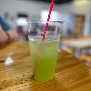 a green drink with a red straw