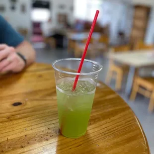 a green drink with a red straw