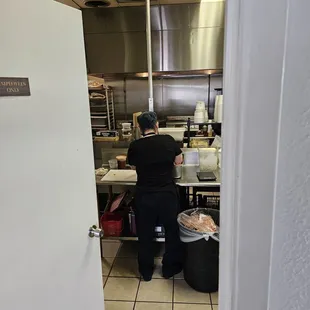 A view into the kitchen. Trimming whole brisket for menu items. Everything here is fresh and homemade.
