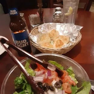 a plate of salad and a bottle of beer
