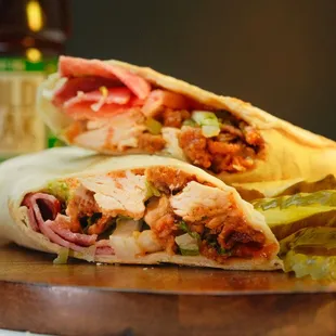 Divine Angel Chicken Wrap: sliced fried chicken breast with slices pickles, tomato, onion, lettuce, ranch, and turkey bacon