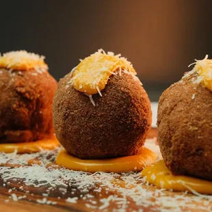 Jumbo Mac and Cheese fried balls: Baseball-sized mounds of mac and cheese deep fried and topped with cheddar cheese sauce and parmesean