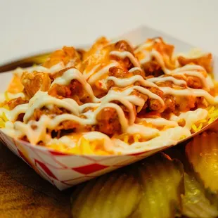 Flaming Chicken Rizo: slices of fried chicken breast on top a bed of seasoned rice, topped with Angel's Secret sauce