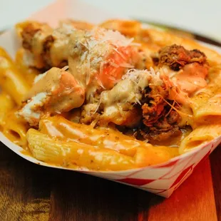 Pasta Dynamite: Cheese Penne pasta tossed in spicy Dynamite sauce, with your choice of fried chicken or crispy shrimp