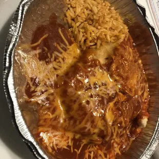 Adovada carne soapapilla with red sauce and rice and beans