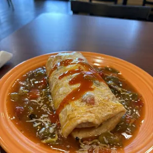 a burrito on an orange plate