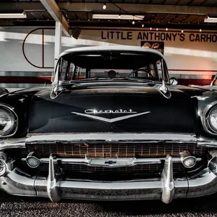 a classic car in a garage