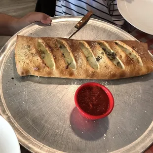 a long loaf of bread on a tray