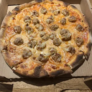 a pizza in a cardboard box