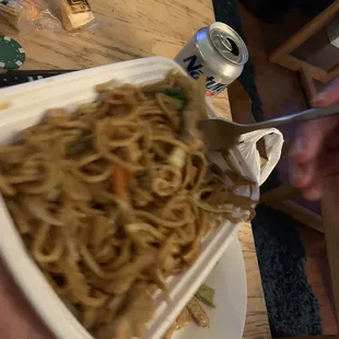 a person eating noodles