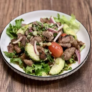 Moo Yang Salad
Our special Thai BBQ pork tender, mints, red onion, scallion, cucumber, and cherry tomato with chili lime dressing.