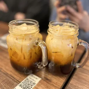 two glasses of iced coffee on a table