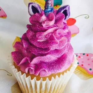 a unicorn cupcake with pink frosting