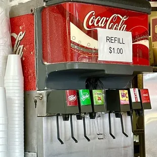 a coca cola machine and cups