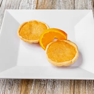 two oranges on a white plate