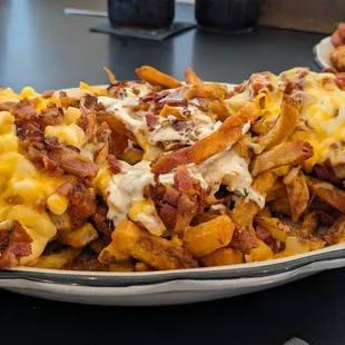 Trio Flight of Fries - Mac &amp; Cheese; Bacon Cheddar Ranch; Chili Cheese Fries | There&apos;s some non-exciting chicken tenders in the background.