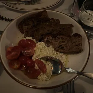 Stracciatella with bread and cherry tomatoes
