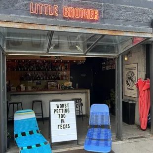 two lounge chairs in front of a store