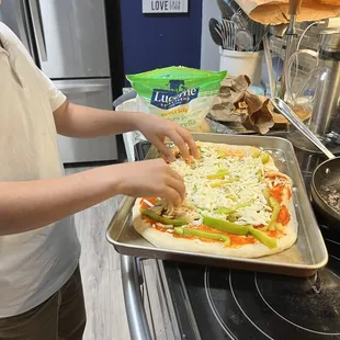 Building pizza at home with little brother pizza dough!