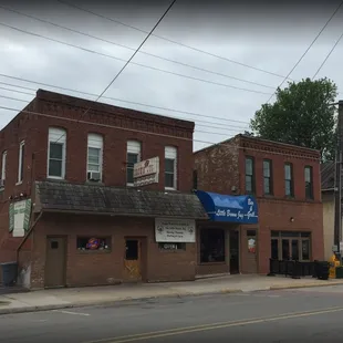 a brick building with a blue awning