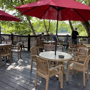 tables and chairs with red umbrellas