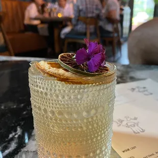 a glass with a flower in it