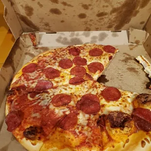a half eaten pepperoni pizza