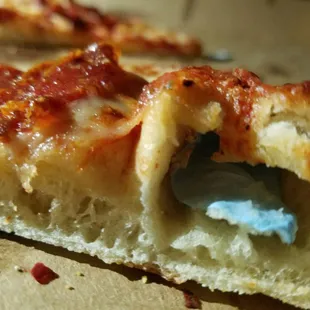 a slice of pizza with a bite taken out of it