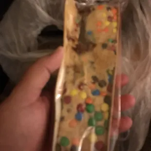 a hand holding a cookie