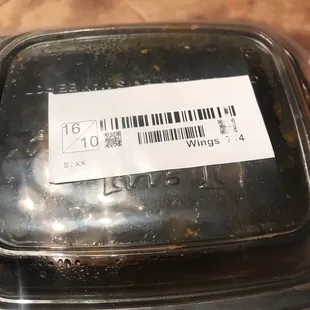 a piece of pizza in a plastic container