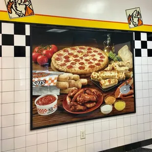 a pizza and other food items