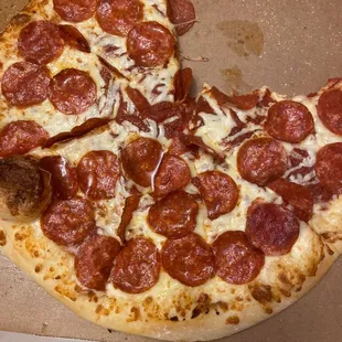 a half eaten pepperoni pizza