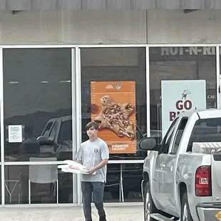 a boy holding a pizza