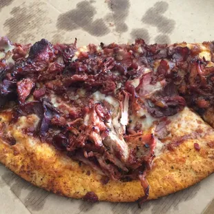 Smokehouse BBQ pizza. We ate 1/2 before photo! Ton of meat, tangy sauce, seasoned crust. The crust is actually good.