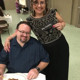 a man and a woman at a table with a plate of food