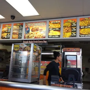 a woman standing in front of a menu