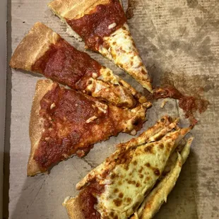 four slices of pizza in a pizza box