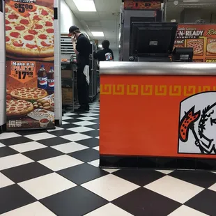 a man behind a counter in a fast food restaurant