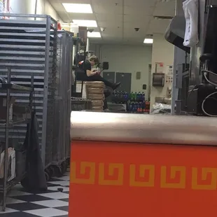 a man in the kitchen behind the counter