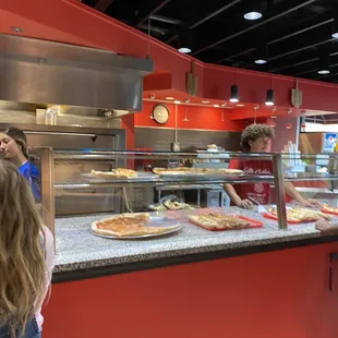 a little girl standing in front of the counter
