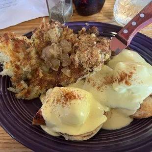 Eggs Bene with ham and hash browns with sautéed onions.