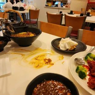 a table of food and people in the background
