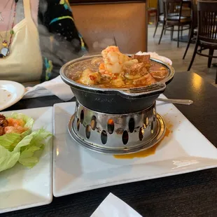 a woman sitting at a table with a plate of food