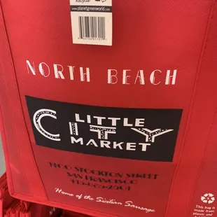 a red shopping cart with red umbrellas